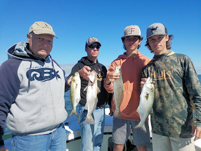 Charter group holding some fish recently caught.