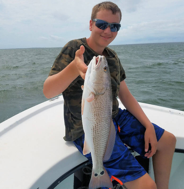 Taylor holds up a nice Red Drum.