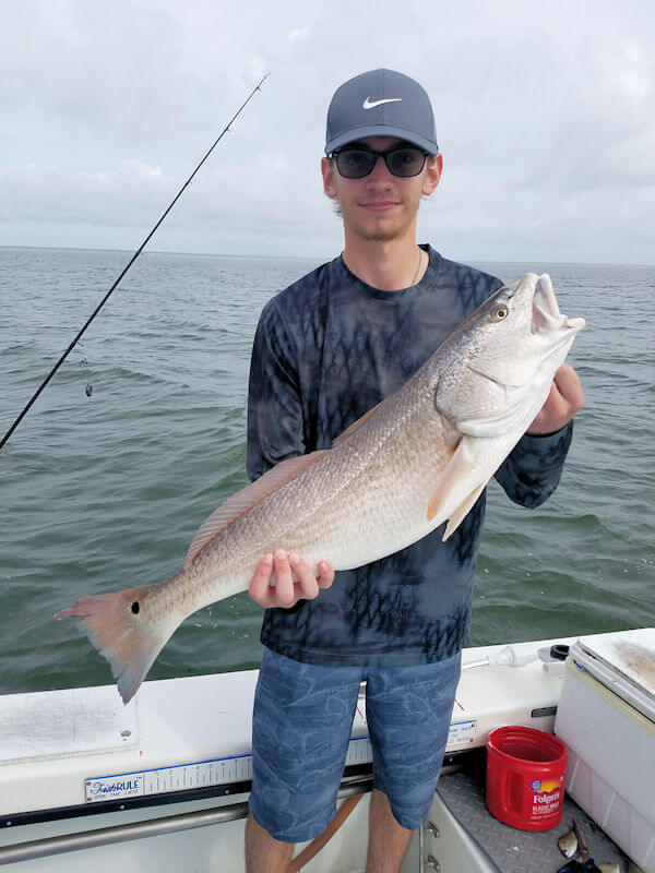 Young angler showing off one of her larger Red Drum for Pamilco Sound.