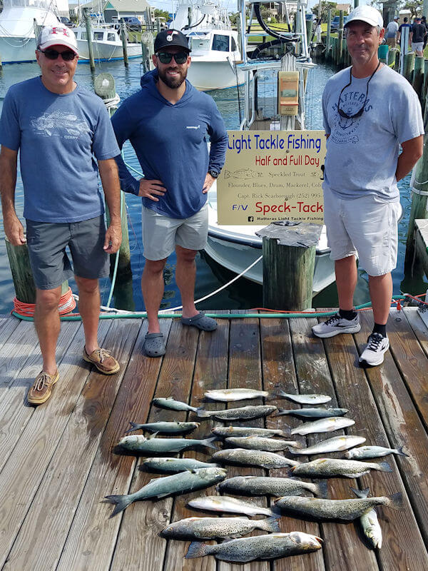 Tim, Tim Jr. and Mark standing at the dock displaying their great catch of Speckled Trout.