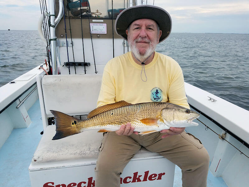 Angler holds his big Pamlico Sound Red Drum.
