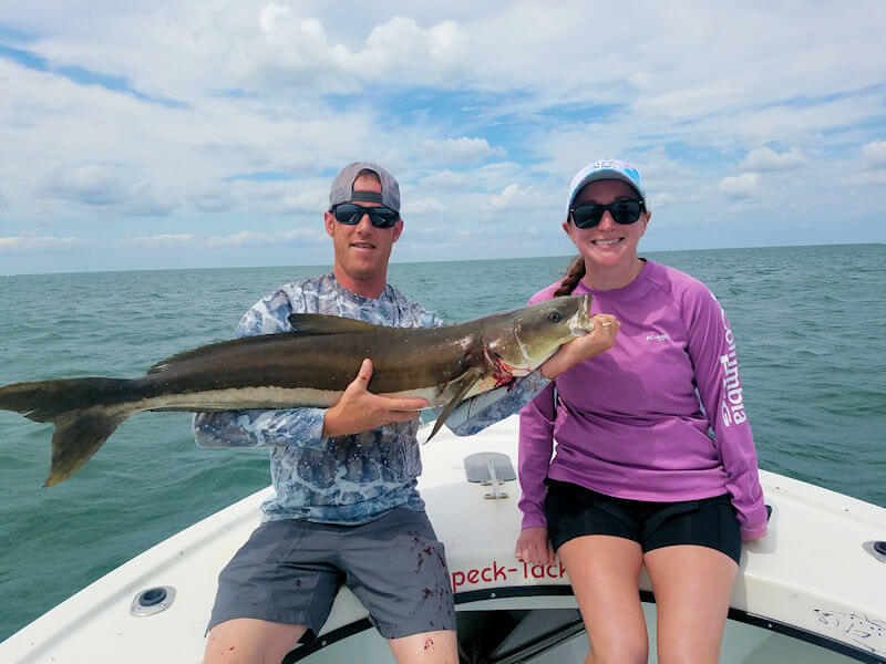 Jonathan Howard holds his big 32 pound Cobia he caught on his honeymoon at Hatteras.